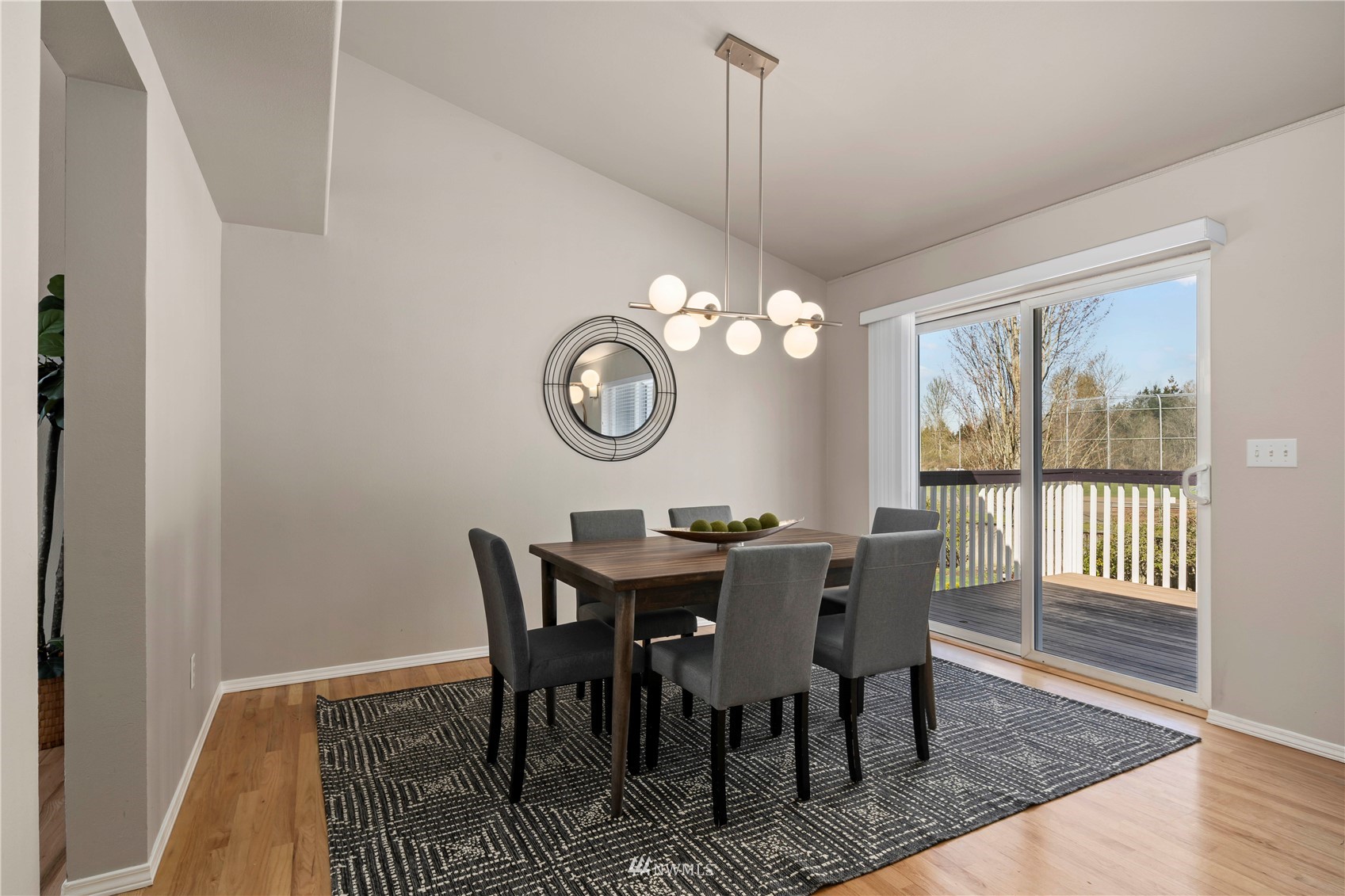 4518 Northeast 7th Place Renton, WA 98059 - Photo 7 of 24 a view of a dining room with furniture a chandelier and wooden floor