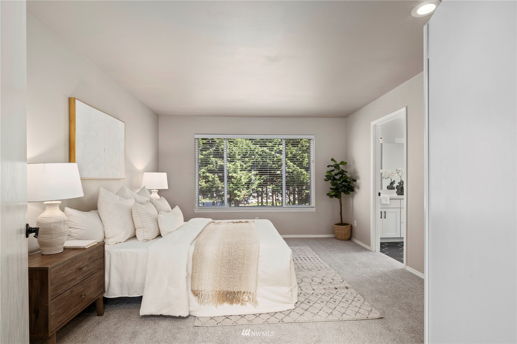 4518 Northeast 7th Place Renton, WA 98059 - Photo 8 of 24 a spacious bedroom with a bed and a large window