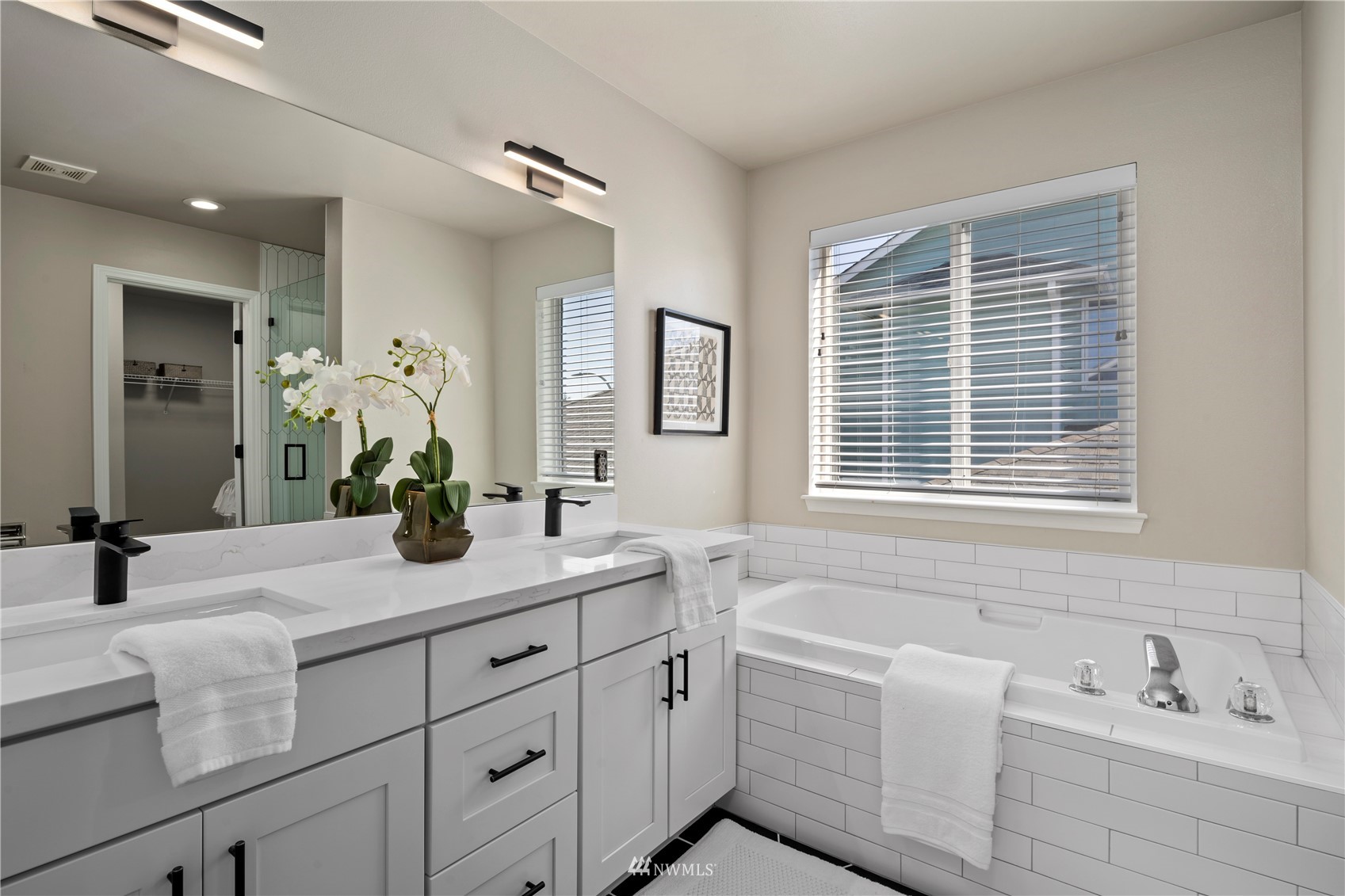4518 Northeast 7th Place Renton, WA 98059 - Photo 10 of 24 a bathroom with a granite countertop sink mirror and bathtub