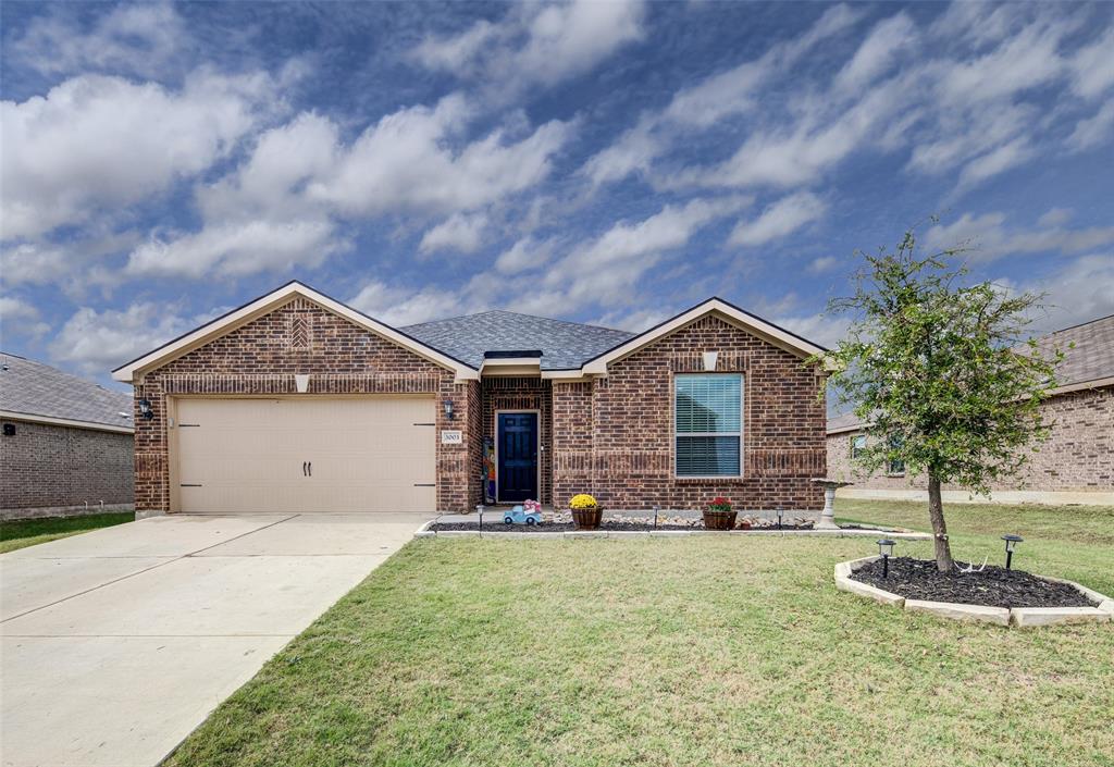a view of a house with a yard and garage