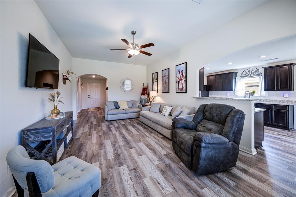 3003 Watercrest Drive Sanger, TX 76266 - Photo 7 of 21 a living room with furniture a flat screen tv and a fireplace
