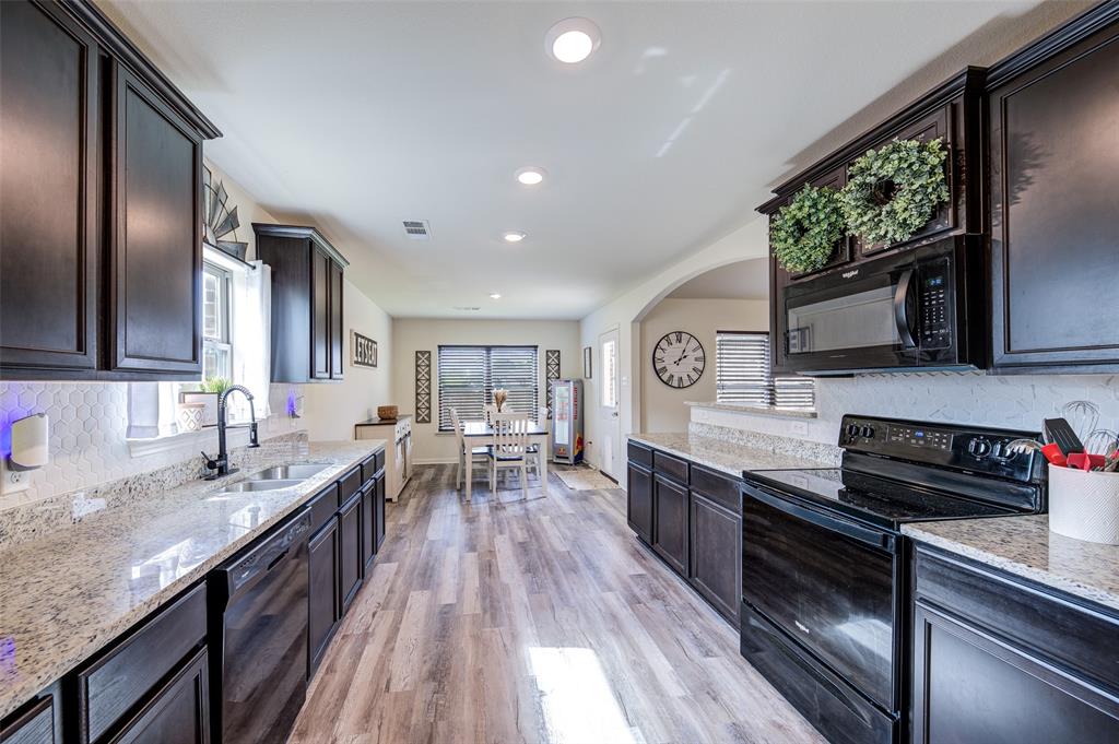3003 Watercrest Drive Sanger, TX 76266 - Photo 8 of 21 a kitchen with stainless steel appliances granite countertop sink stove top oven and cabinets