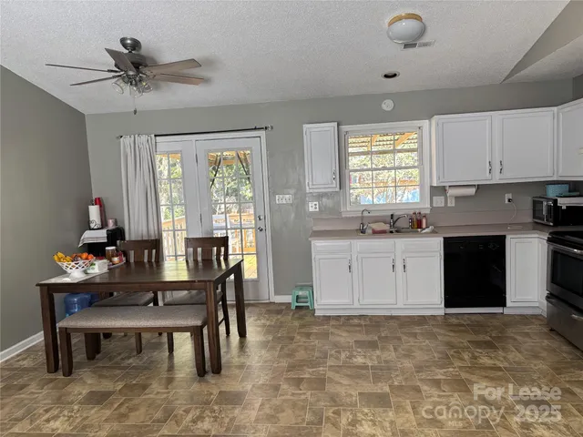 a kitchen with a table chairs and a refrigerator