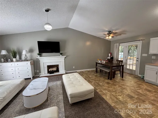 a living room with furniture a fireplace and a flat screen tv