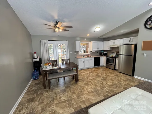 a living room with kitchen island furniture and a kitchen view