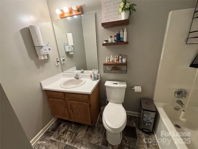 a bathroom with a sink toilet and a mirror