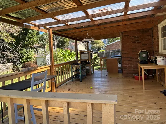 a view of a porch with furniture and a yard