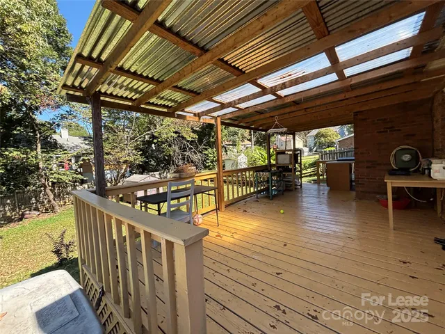 a view of a swimming pool with a deck and furniture