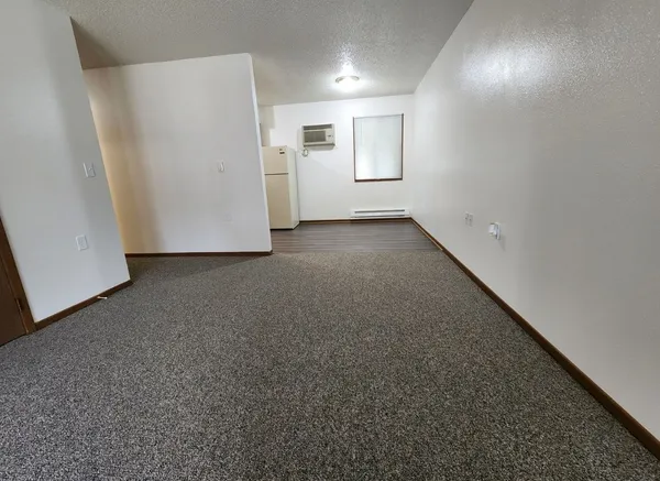 a view of a livingroom with a refrigerator
