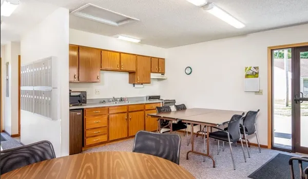 a kitchen with a sink a stove and cabinets