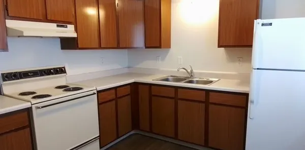 a white refrigerator freezer sitting inside of a kitchen