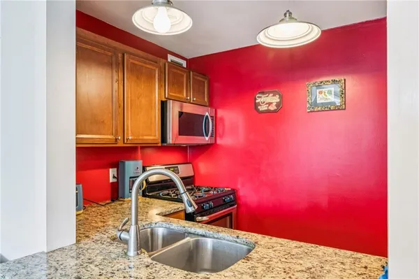 a kitchen with a sink and a counter top space