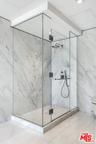 a bedroom with a large bed and a desk