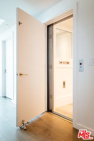 a roof deck with couches and potted plants