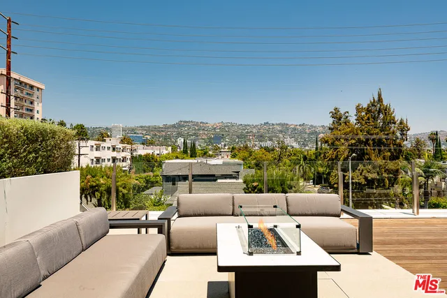 a view of a couches and dinning table in the patio
