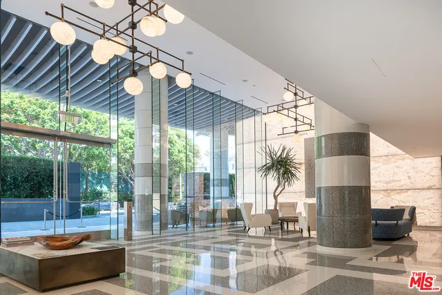 a living room with furniture a flat screen tv and a window