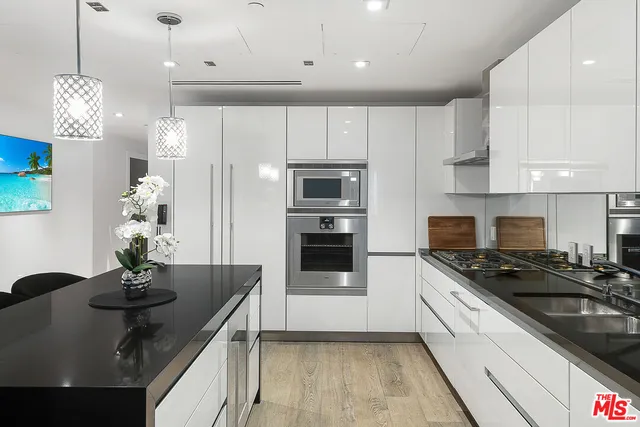 a kitchen with granite countertop a sink stainless steel appliances and cabinets