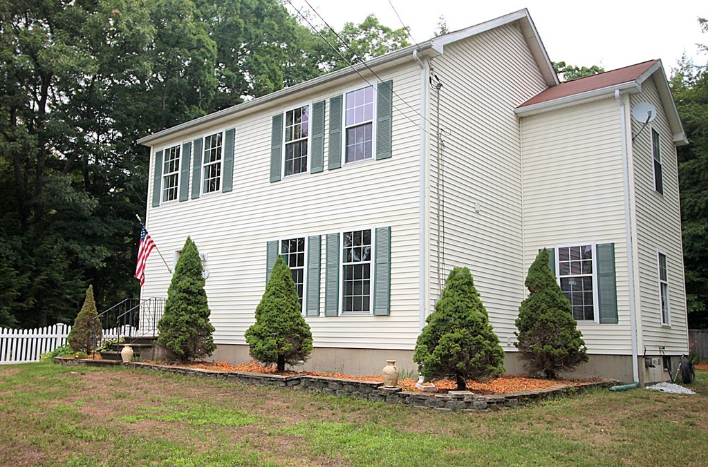 65 High Street Erving, MA 01344 - Photo 2 of 39 a front view of a house with a yard and garage