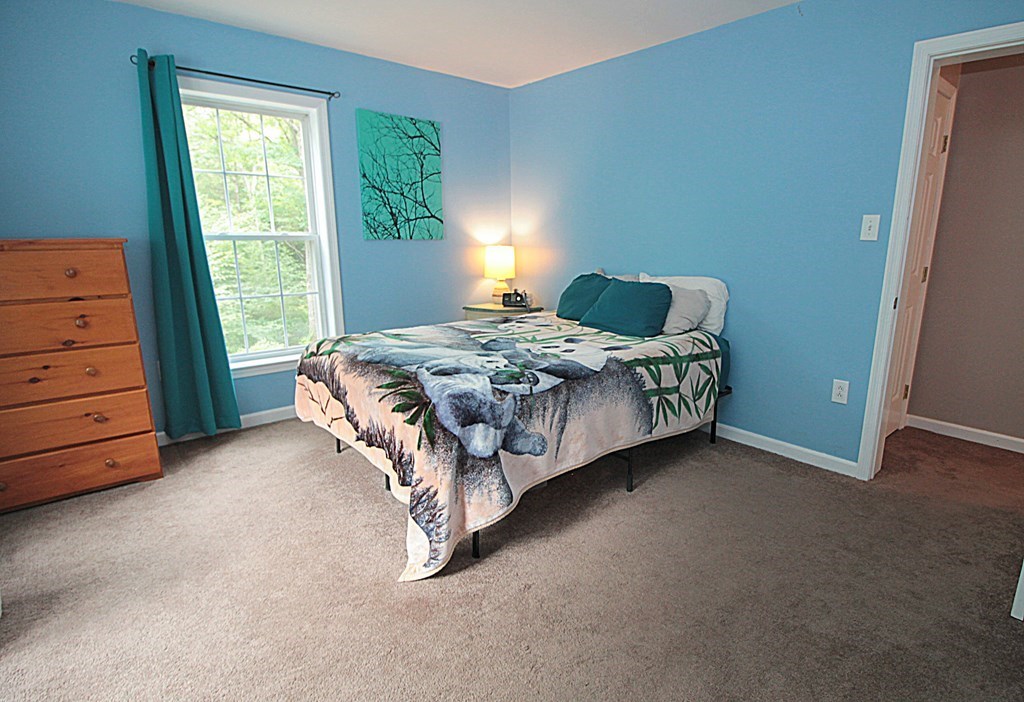 65 High Street Erving, MA 01344 - Photo 22 of 39 a bed sitting in a bedroom next to a window