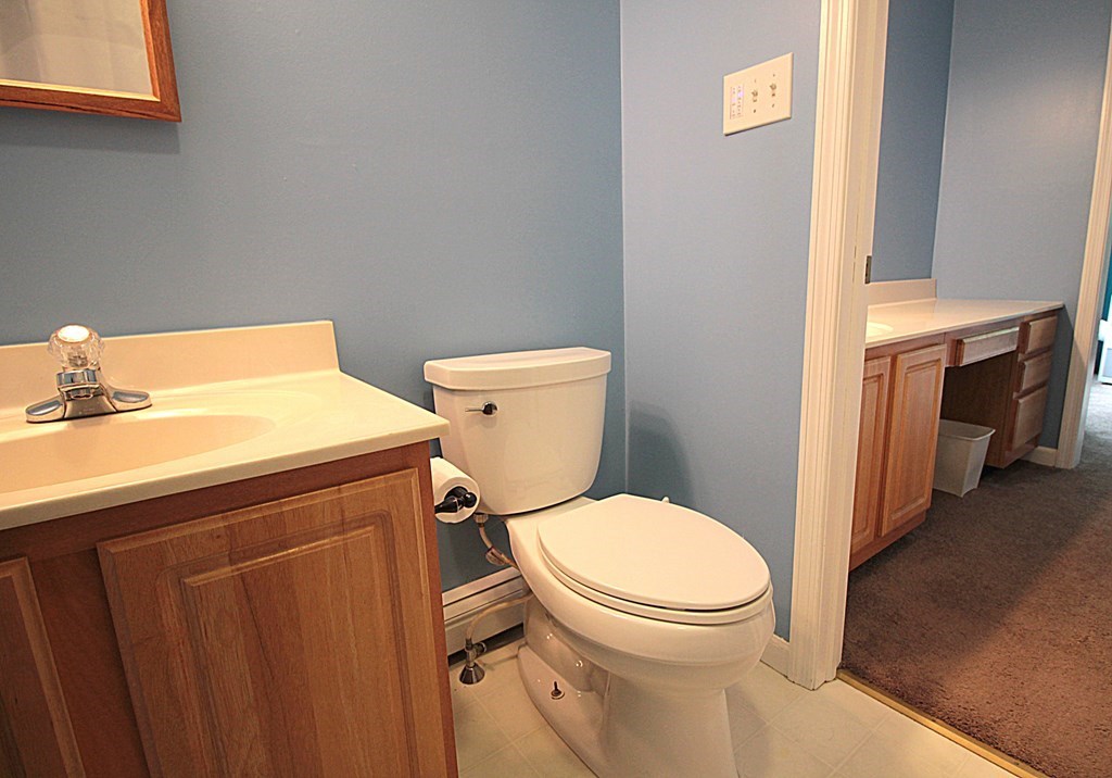 65 High Street Erving, MA 01344 - Photo 25 of 39 a white toilet sitting next to a bathroom sink