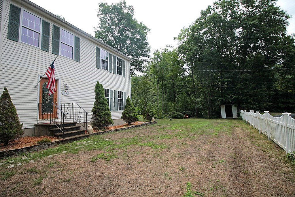 65 High Street Erving, MA 01344 - Photo 3 of 39 a front view of a house with a yard