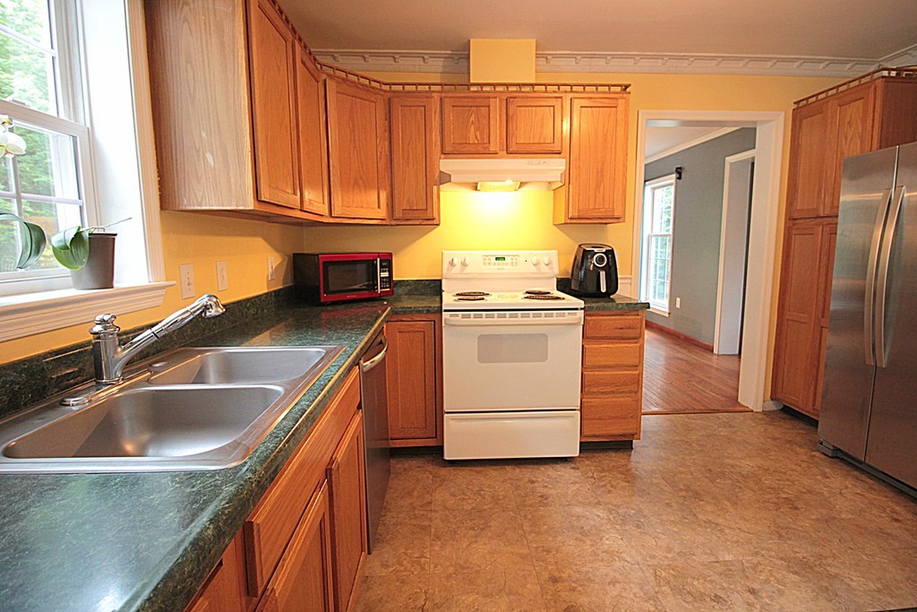 65 High Street Erving, MA 01344 - Photo 6 of 39 a kitchen with stainless steel appliances granite countertop a sink stove and refrigerator