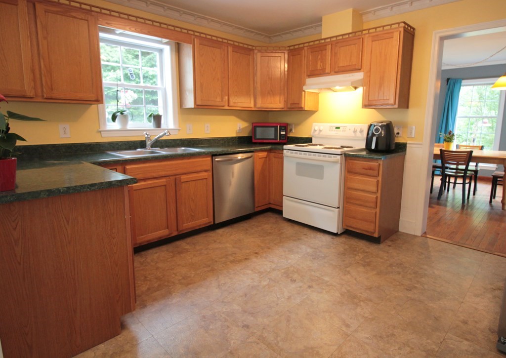 65 High Street Erving, MA 01344 - Photo 7 of 39 a kitchen with granite countertop a sink cabinets stainless steel appliances and a window