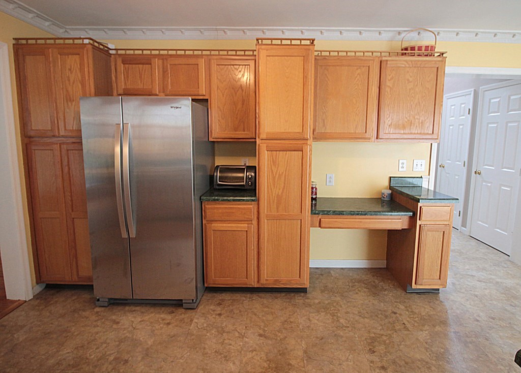 65 High Street Erving, MA 01344 - Photo 8 of 39 a kitchen with stainless steel appliances a refrigerator and a cabinets