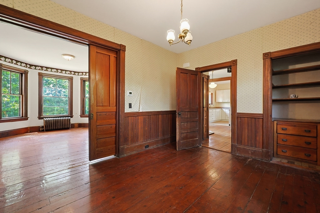 7 Baker Street Worcester, MA 01603 - Photo 13 of 42 an empty room with wooden floor closet and windows