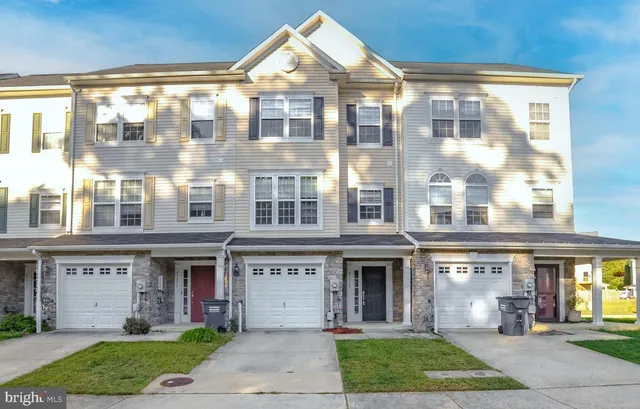a front view of a brick house with a yard
