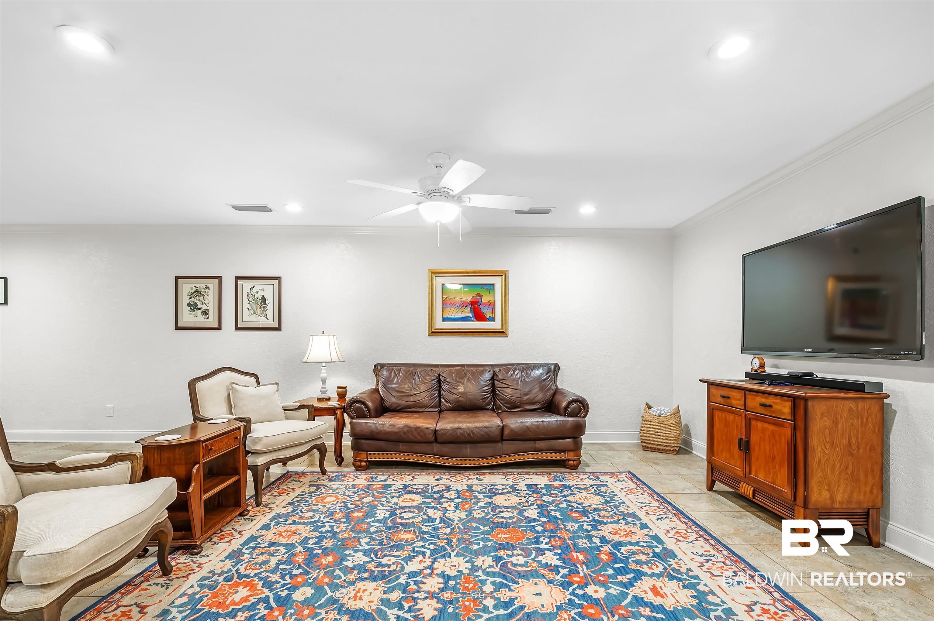 104 James Circle Daphne, AL 36526 - Photo 21 of 62 Living room featuring light tile patterned flooring, ceiling fan, and ornamental molding