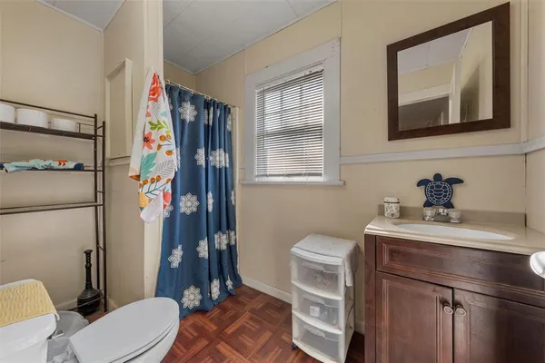 a bathroom with a toilet sink and mirror