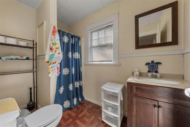 a bathroom with a toilet sink and mirror