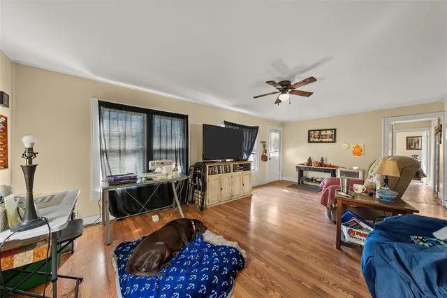 a living room with furniture a flat screen tv and a table