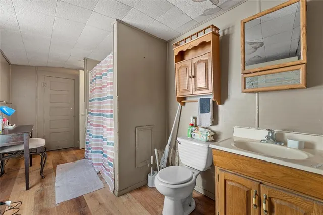 a bathroom with a sink toilet and a mirror