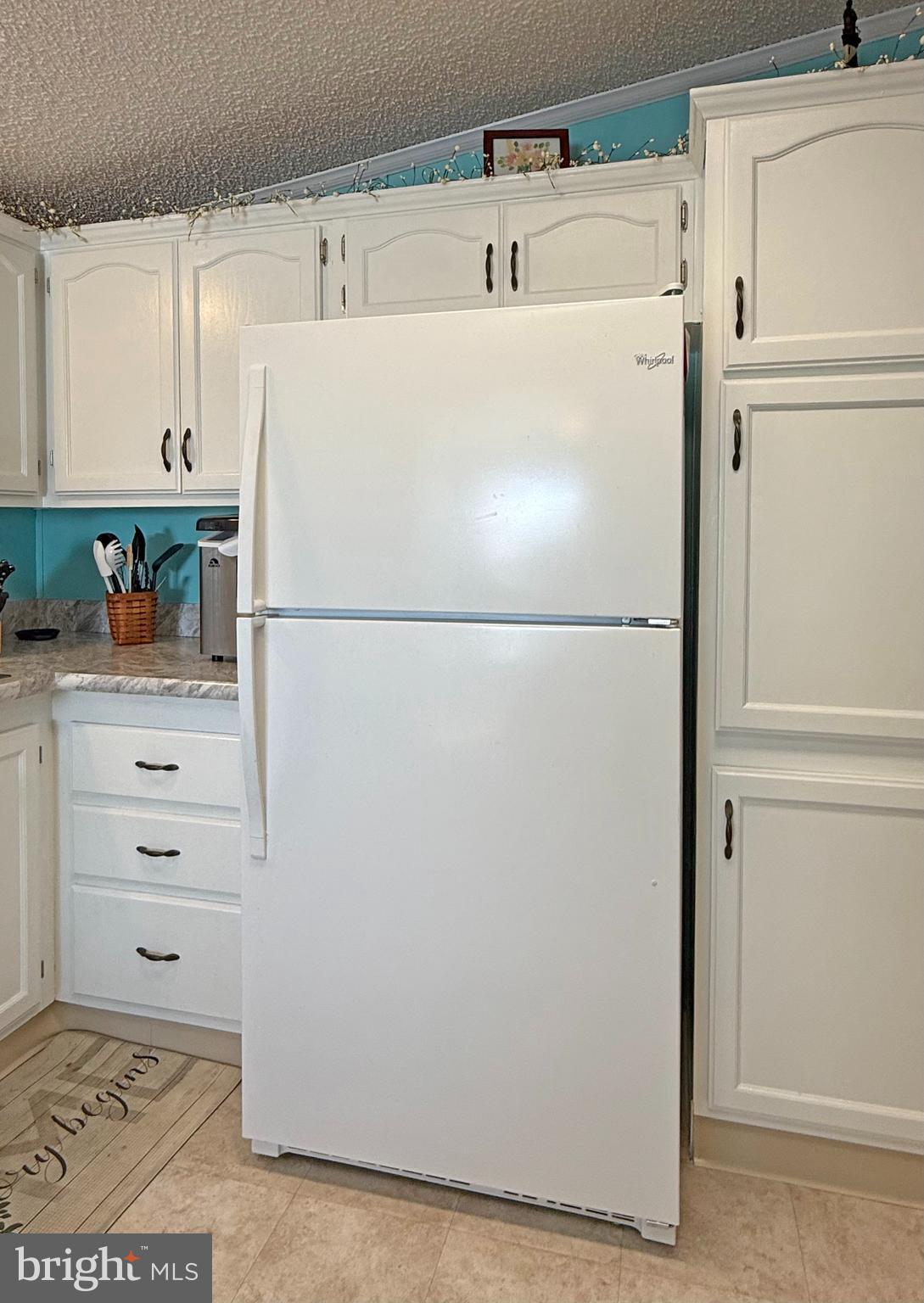 27137 Clipper Road, Unit M55 Millsboro, DE 19966 - Photo 12 of 48 a white refrigerator freezer sitting in a kitchen