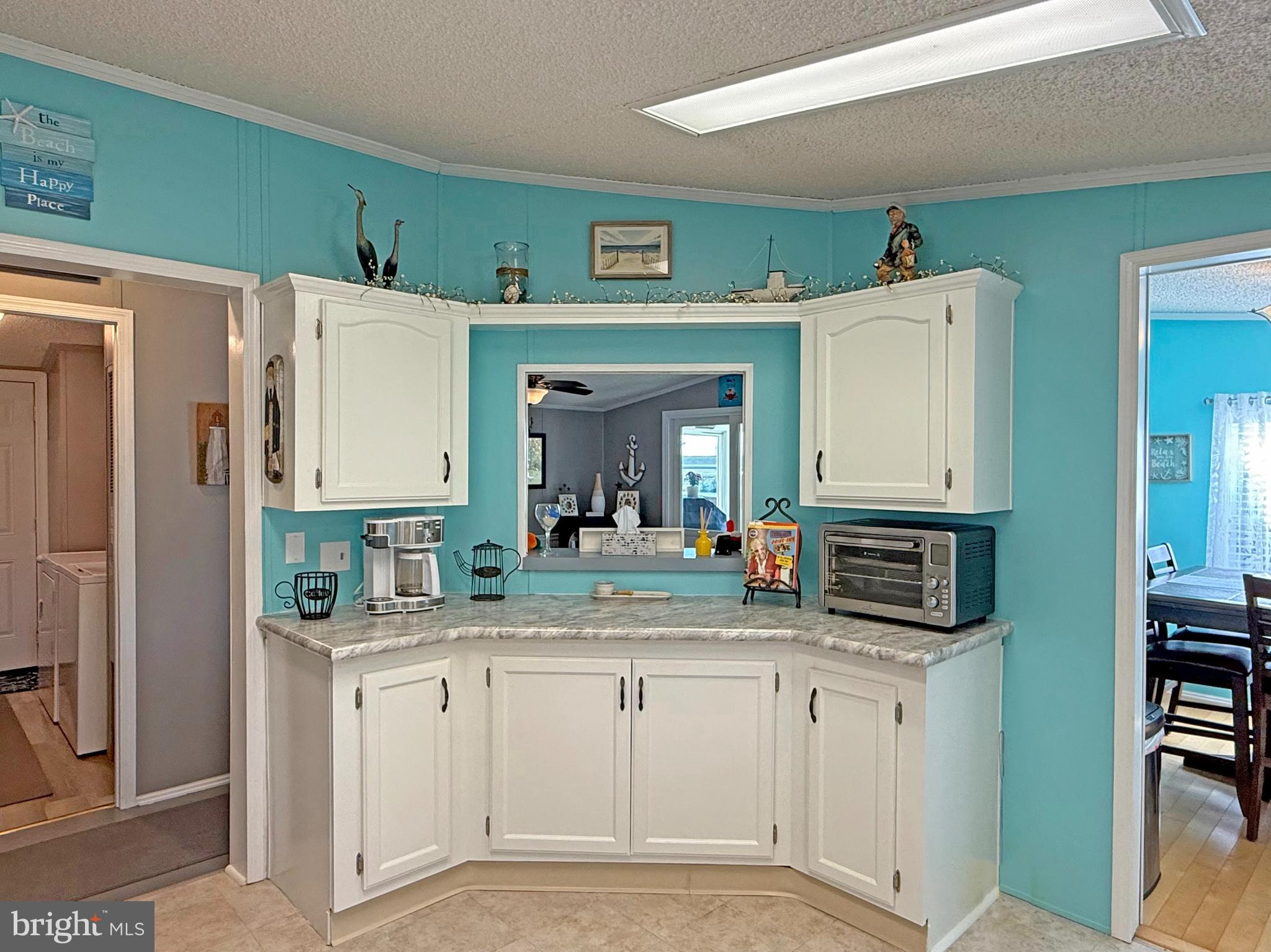 27137 Clipper Road, Unit M55 Millsboro, DE 19966 - Photo 14 of 48 a kitchen with stainless steel appliances a sink stove and refrigerator