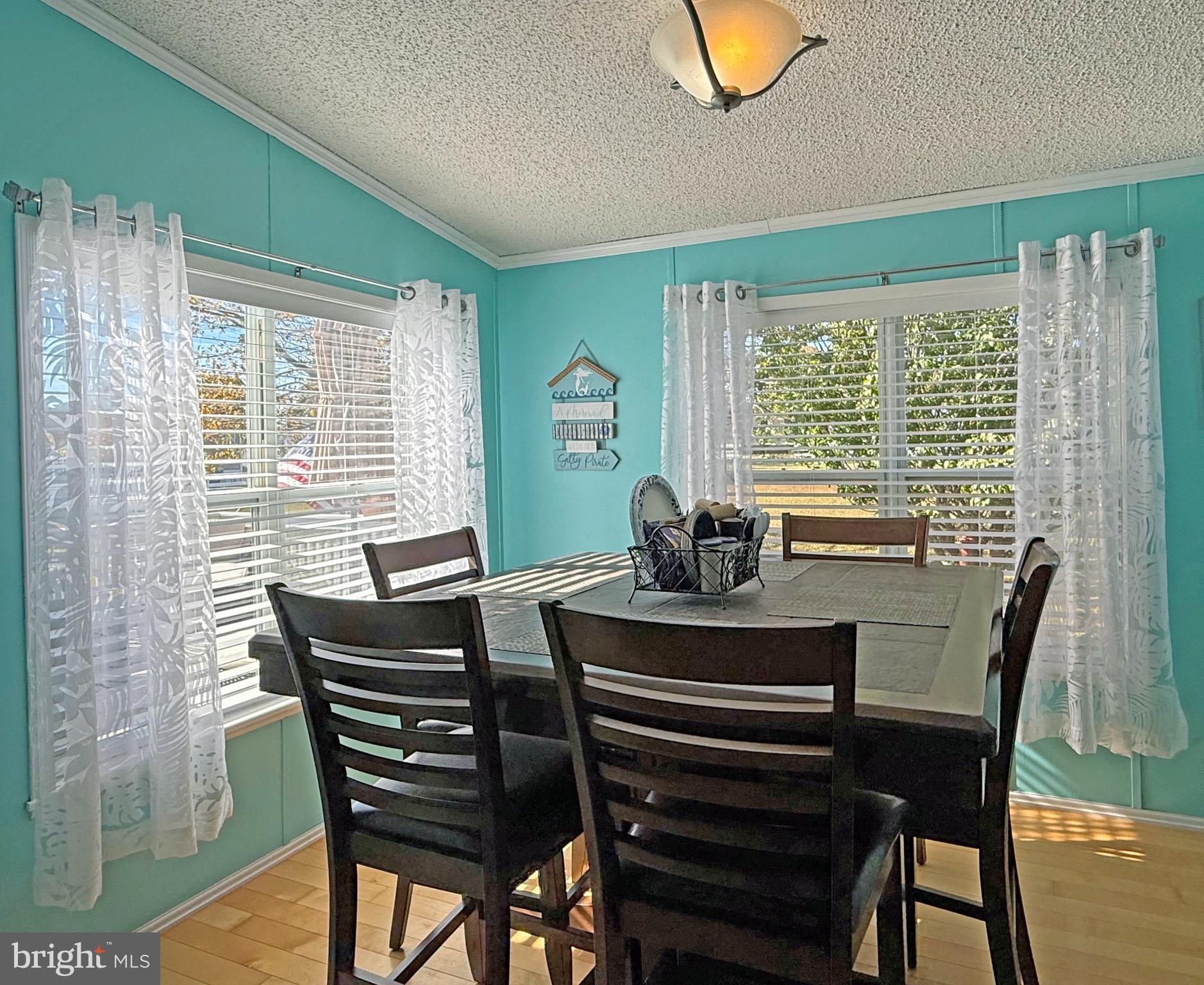 27137 Clipper Road, Unit M55 Millsboro, DE 19966 - Photo 15 of 48 a view of a dining room with furniture and a window