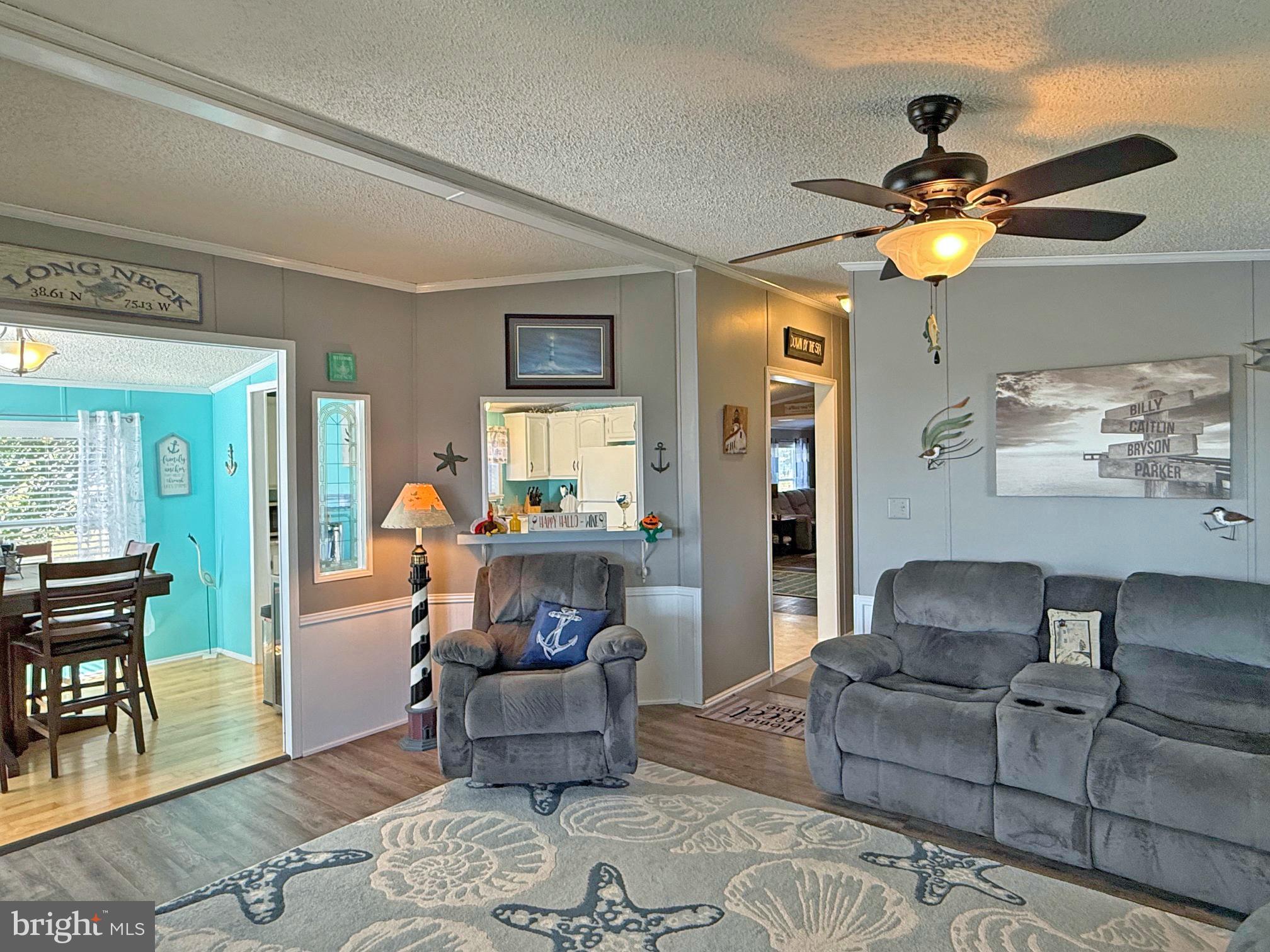 27137 Clipper Road, Unit M55 Millsboro, DE 19966 - Photo 16 of 48 a living room with furniture and a lamp