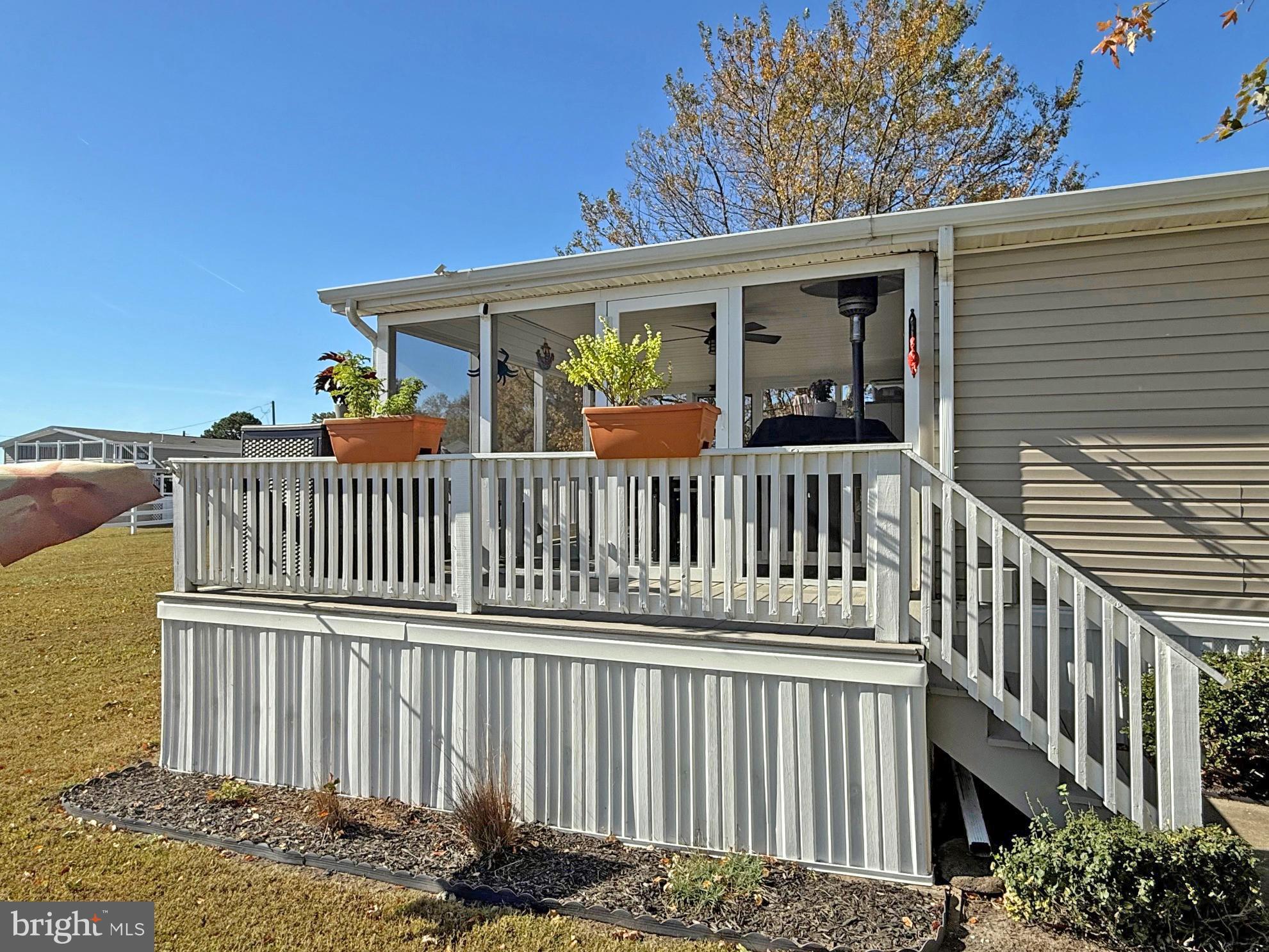 27137 Clipper Road, Unit M55 Millsboro, DE 19966 - Photo 21 of 48 a view of a house with a deck