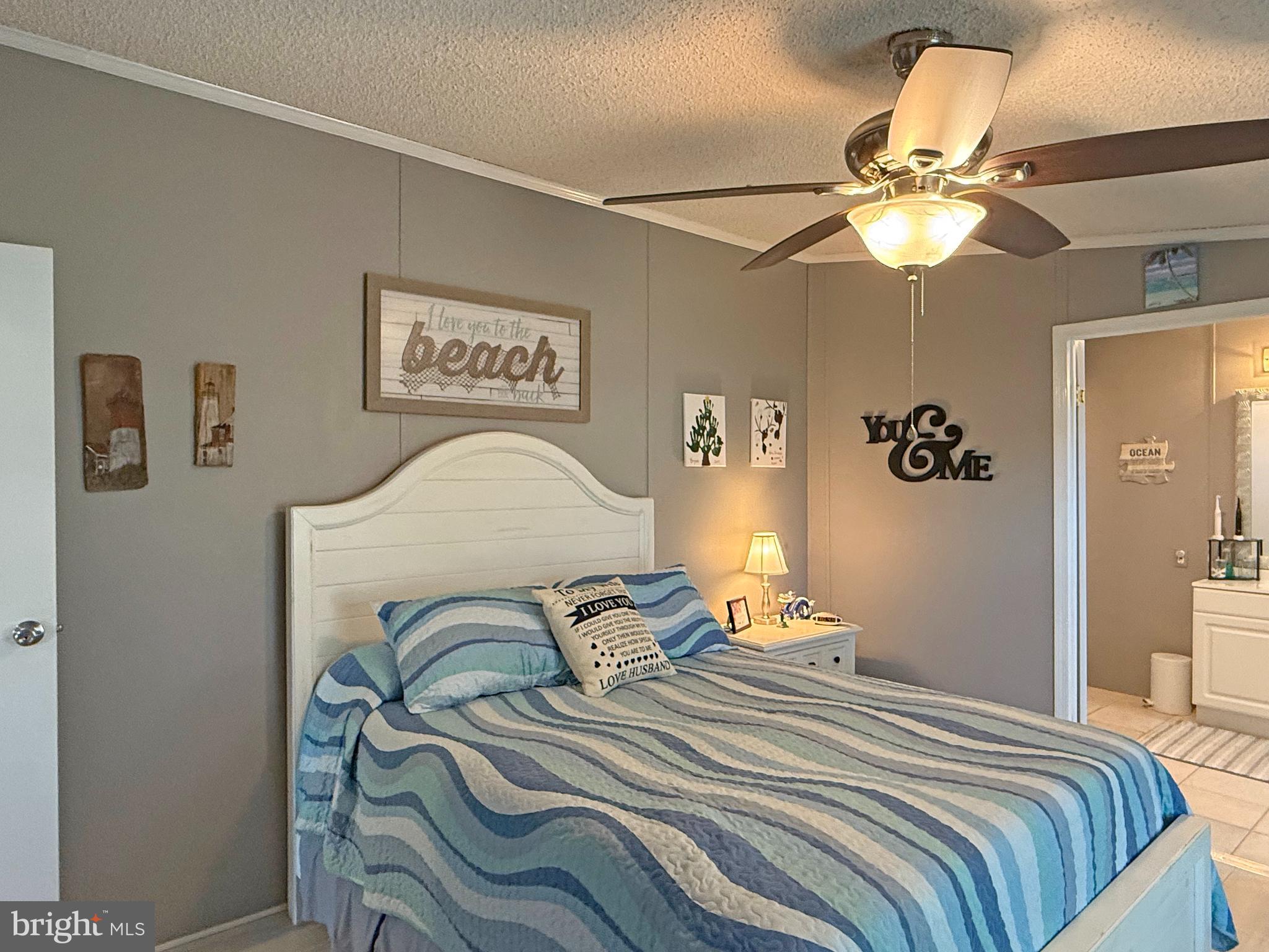 27137 Clipper Road, Unit M55 Millsboro, DE 19966 - Photo 26 of 48 a bedroom with a bed and a chandelier