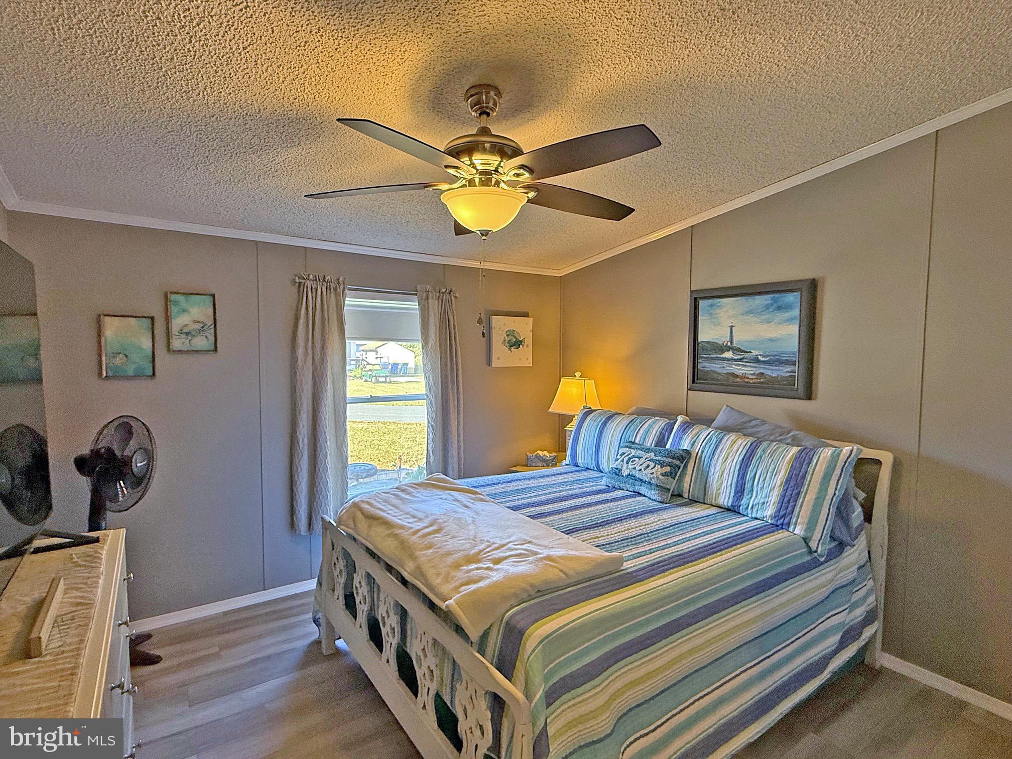 27137 Clipper Road, Unit M55 Millsboro, DE 19966 - Photo 31 of 48 a bedroom with a bed and a window