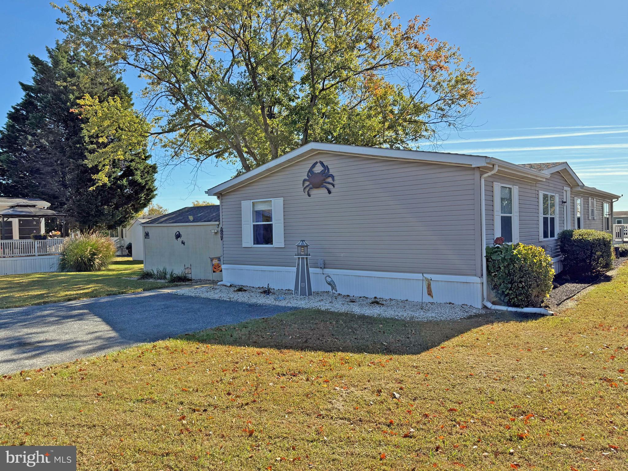 27137 Clipper Road, Unit M55 Millsboro, DE 19966 - Photo 40 of 48 a front view of house with yard and trees in the background