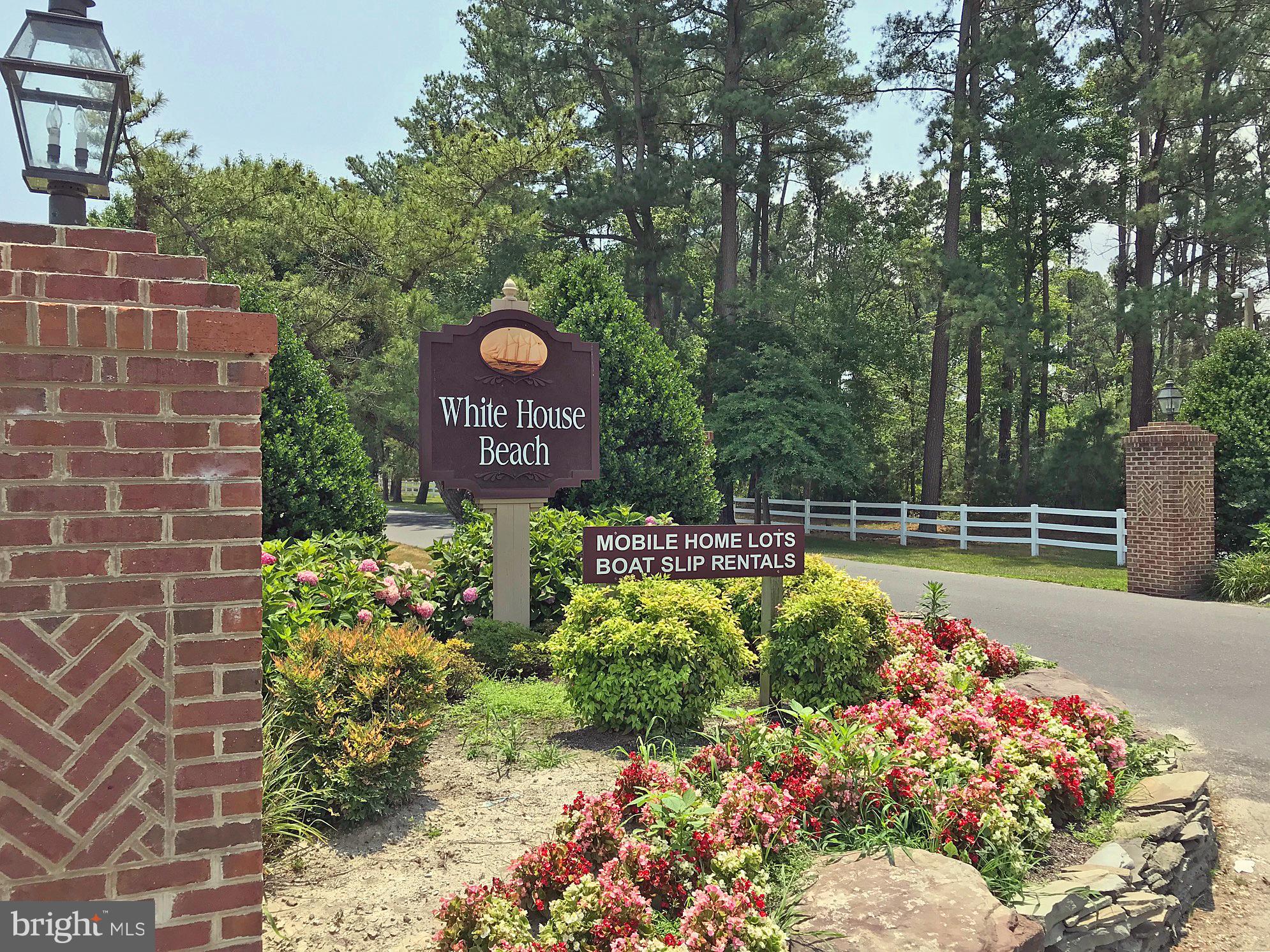 27137 Clipper Road, Unit M55 Millsboro, DE 19966 - Photo 44 of 48 a view of a swimming pool with a bench in the background