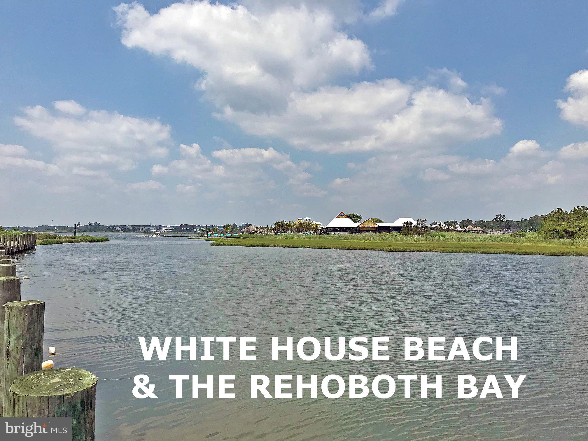 27137 Clipper Road, Unit M55 Millsboro, DE 19966 - Photo 45 of 48 a view of a lake with houses with outdoor space
