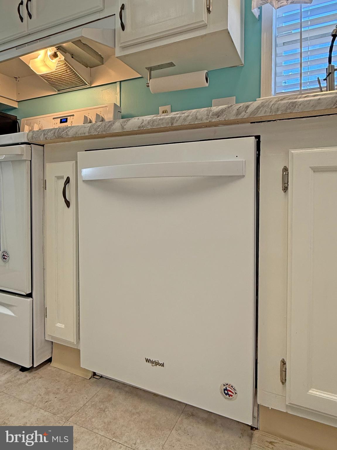 27137 Clipper Road, Unit M55 Millsboro, DE 19966 - Photo 10 of 48 a view of a refrigerator with wooden floor