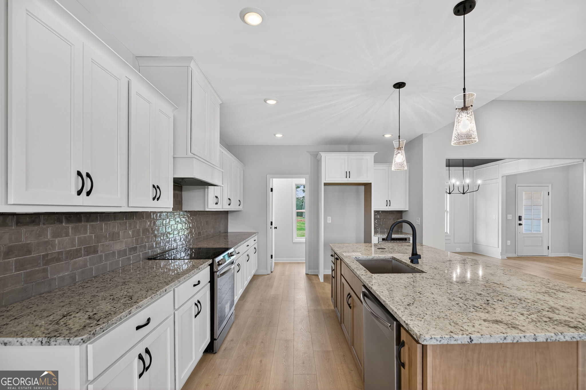 359 Gray Road Roopville, GA 30170 - Photo 19 of 46 a kitchen with stainless steel appliances granite countertop a sink a stove and a wooden floors