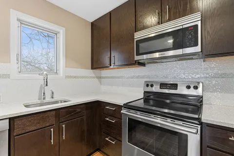 a kitchen with a stove microwave and sink