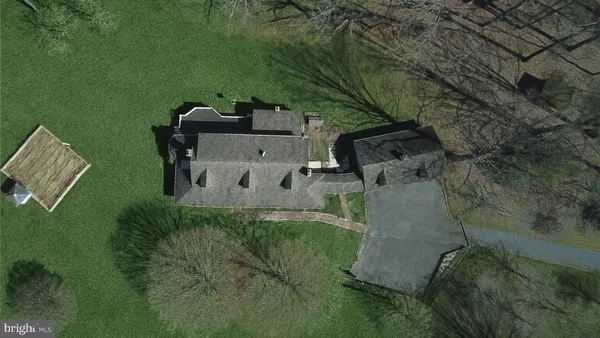 an aerial view of a house with a yard