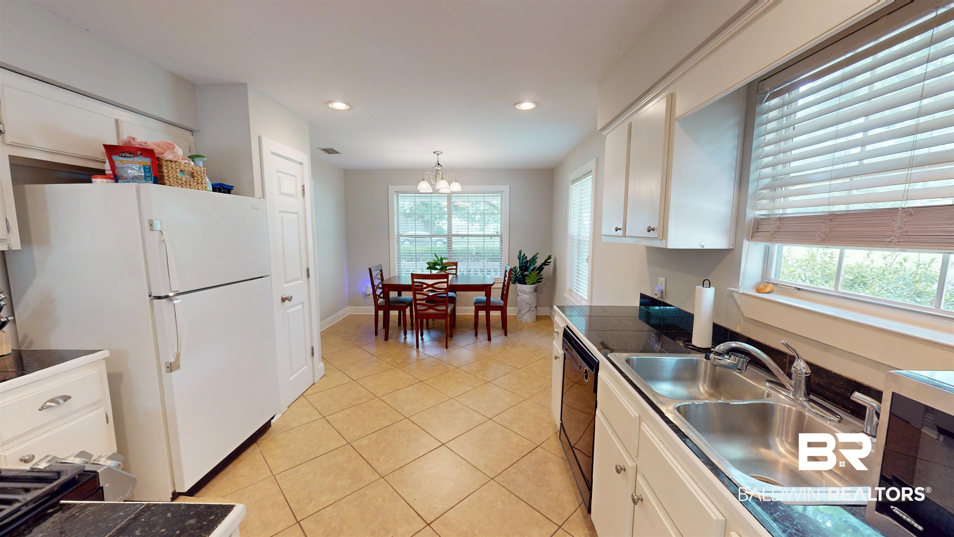 51 Bishop Lane South Mobile, AL 36608 - Photo 4 of 19 Kitchen with white cabinetry, light tile patterned floors, a chandelier, dark countertops, and black dishwasher